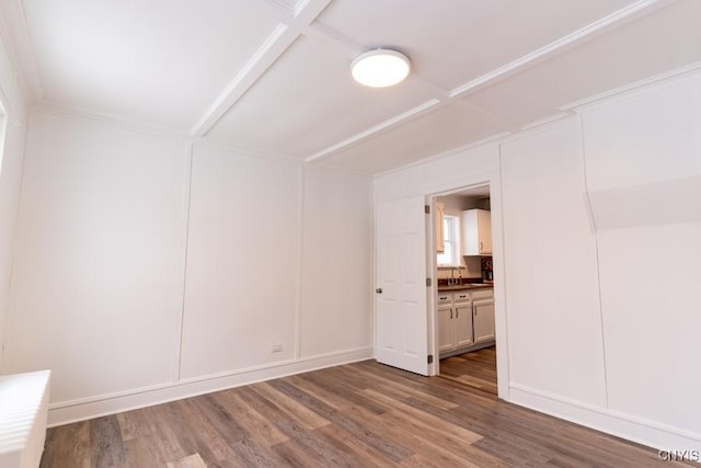 unfurnished room featuring sink, coffered ceiling, and hardwood / wood-style floors