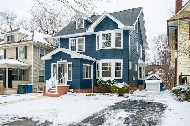 view of front facade featuring an outdoor structure and a garage