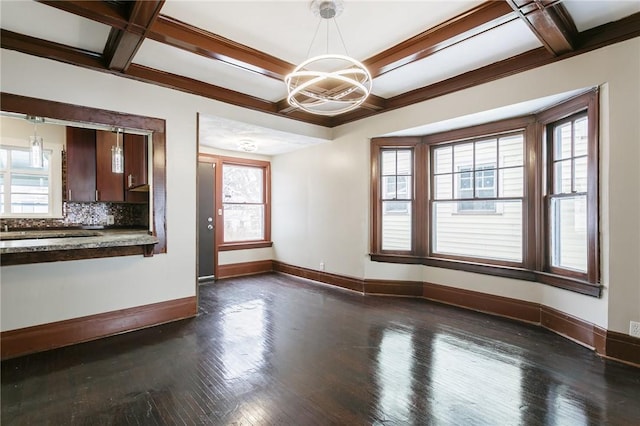 unfurnished dining area featuring dark wood-type flooring, an inviting chandelier, beam ceiling, and coffered ceiling