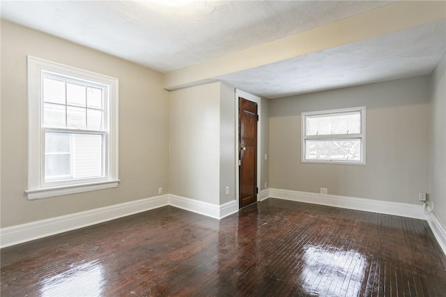 spare room with dark wood-type flooring