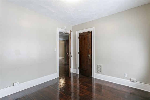 spare room with dark hardwood / wood-style flooring