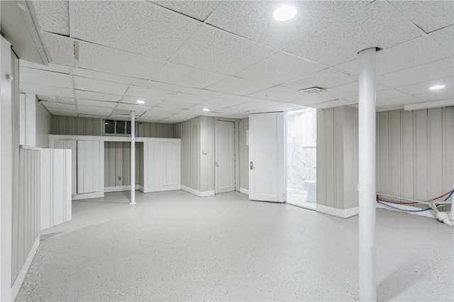 basement featuring a paneled ceiling