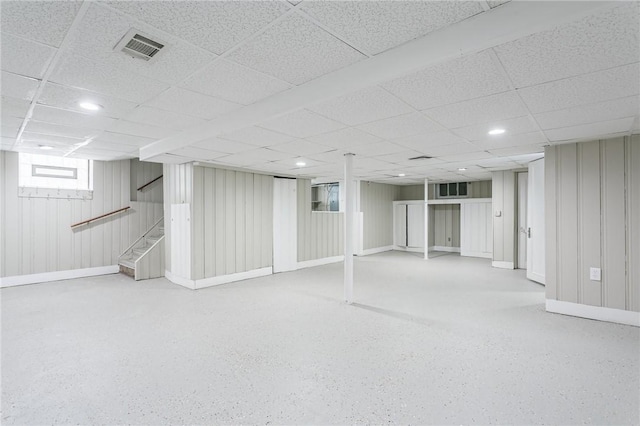 basement with a paneled ceiling