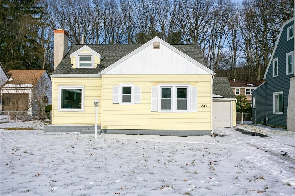 snow covered property featuring a garage