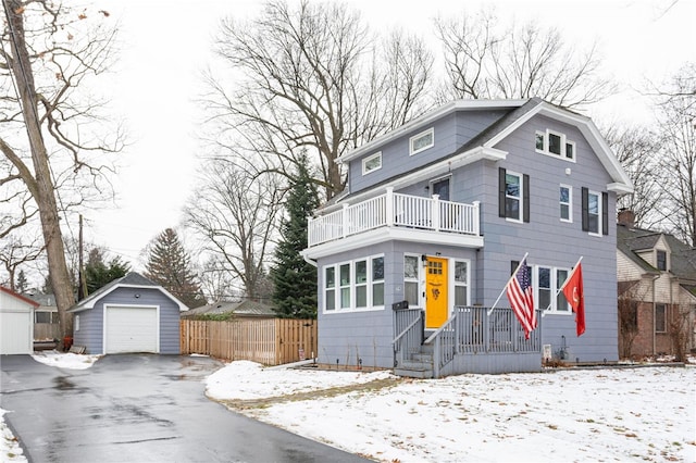 view of front property with an outbuilding, a balcony, and a garage