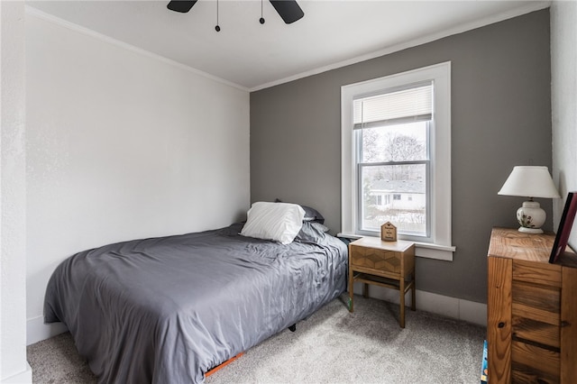 carpeted bedroom featuring ceiling fan and ornamental molding