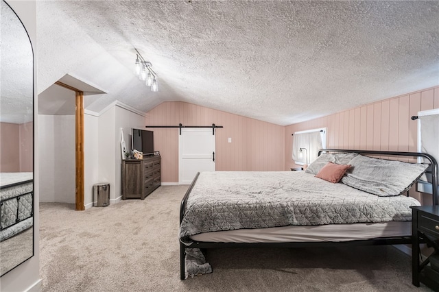 carpeted bedroom with lofted ceiling, wooden walls, and a textured ceiling