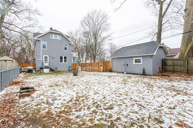 view of snow covered rear of property