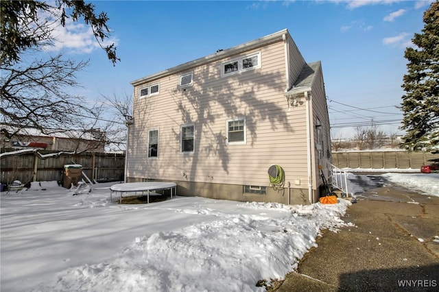 snow covered property with a trampoline