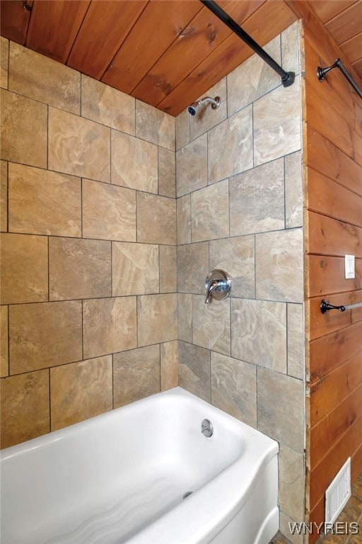 bathroom featuring wooden ceiling and wooden walls