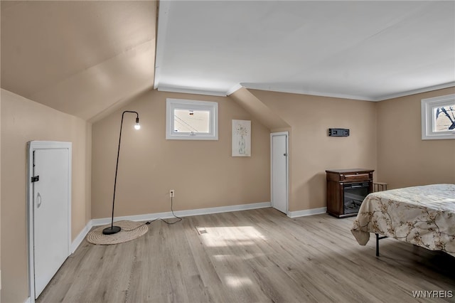 bedroom featuring vaulted ceiling and light hardwood / wood-style floors