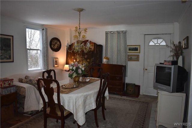 dining space with a notable chandelier and crown molding