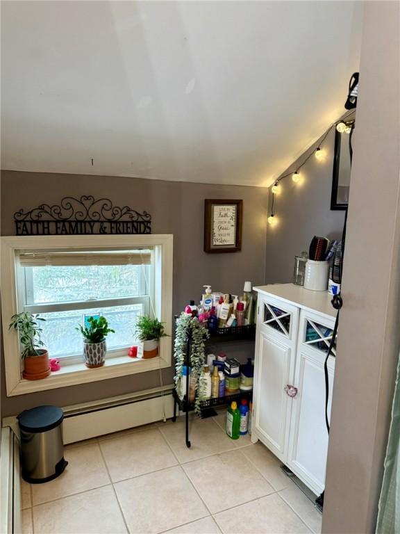 interior space with a baseboard radiator and tile patterned flooring