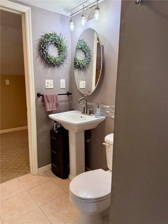 bathroom featuring toilet, sink, and tile patterned floors