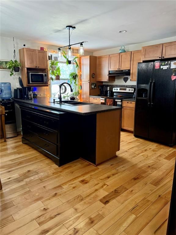 kitchen featuring black refrigerator with ice dispenser, sink, stainless steel electric stove, and light hardwood / wood-style flooring