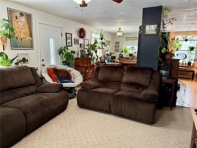 carpeted living room featuring ceiling fan and plenty of natural light