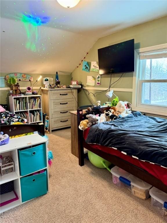 bedroom featuring vaulted ceiling and light colored carpet