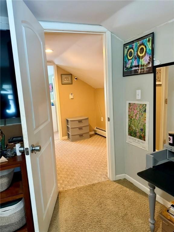 corridor with a baseboard radiator, carpet, and lofted ceiling