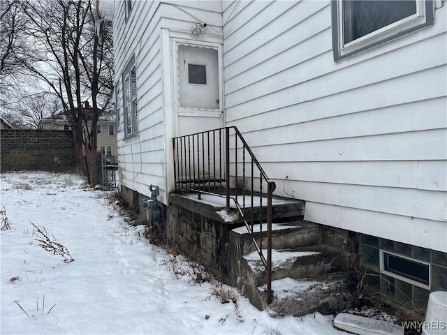 view of snow covered property entrance