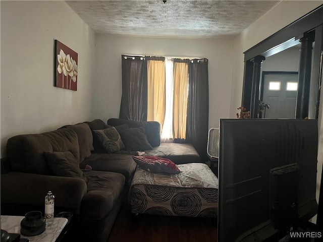 bedroom with a textured ceiling and ornate columns