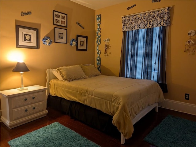 bedroom with dark hardwood / wood-style flooring