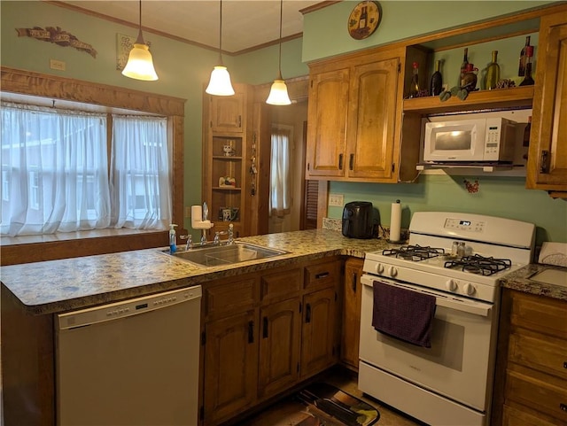 kitchen featuring decorative light fixtures, kitchen peninsula, sink, and white appliances