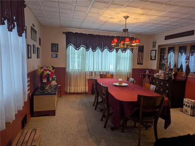 dining area featuring an inviting chandelier