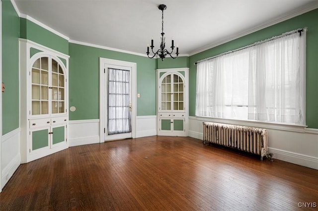 unfurnished dining area with radiator, dark hardwood / wood-style flooring, crown molding, and a chandelier