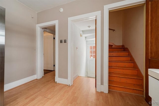 stairs featuring hardwood / wood-style floors