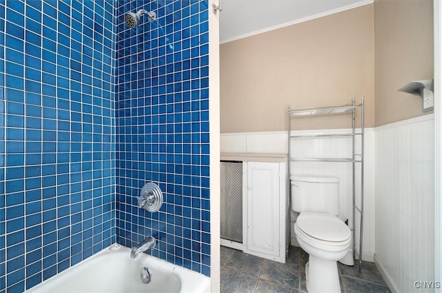 bathroom featuring washtub / shower combination, toilet, and ornamental molding