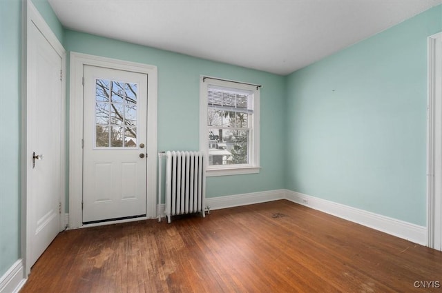 entryway featuring radiator heating unit and dark hardwood / wood-style flooring