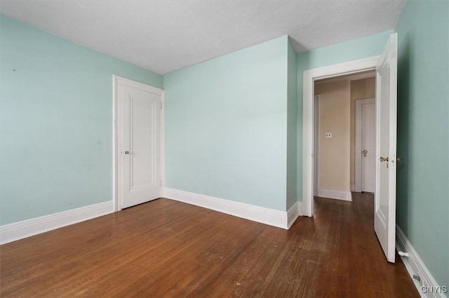 empty room featuring dark hardwood / wood-style floors