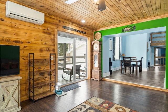 interior space featuring wood walls, a wall mounted AC, wooden ceiling, dark hardwood / wood-style floors, and ceiling fan