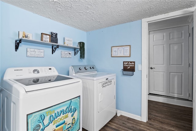 laundry room with washing machine and dryer, dark hardwood / wood-style floors, and a textured ceiling