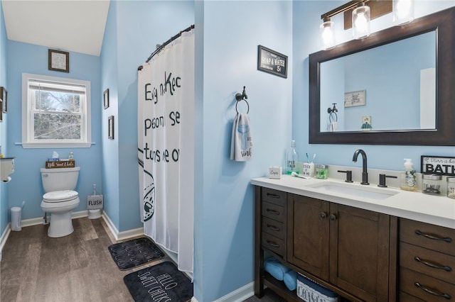 bathroom with walk in shower, vanity, toilet, and hardwood / wood-style floors