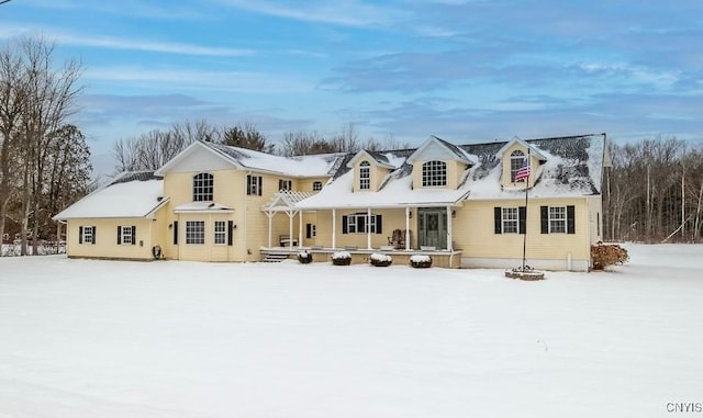 snow covered house with a porch