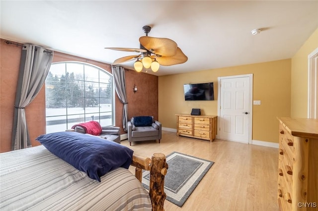 bedroom with ceiling fan and light hardwood / wood-style flooring