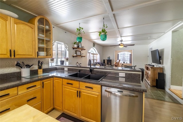 kitchen featuring kitchen peninsula, ceiling fan, dishwasher, wood-type flooring, and sink