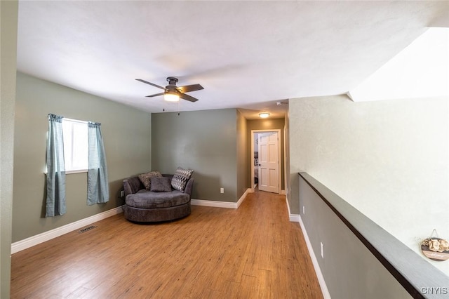 sitting room featuring ceiling fan and light hardwood / wood-style flooring