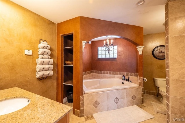 bathroom featuring toilet, a relaxing tiled tub, a notable chandelier, tile patterned floors, and vanity