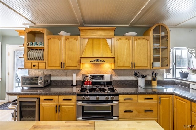 kitchen with custom exhaust hood, wine cooler, backsplash, and stainless steel gas range