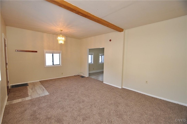 carpeted spare room featuring beam ceiling and an inviting chandelier