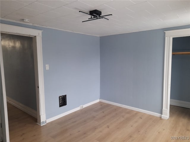 unfurnished bedroom with light wood-type flooring