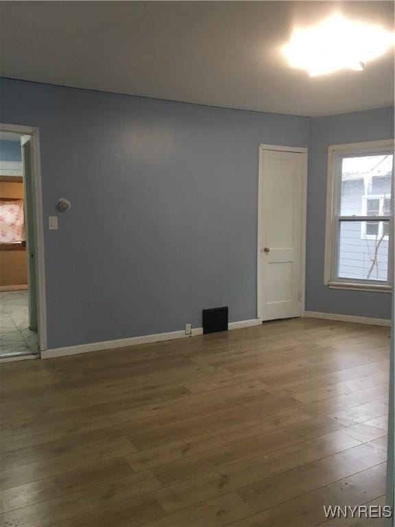 empty room with hardwood / wood-style floors