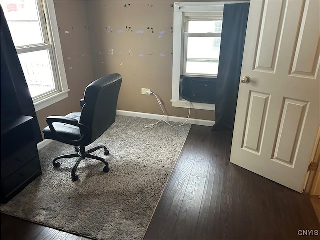 office area with a healthy amount of sunlight and dark hardwood / wood-style floors