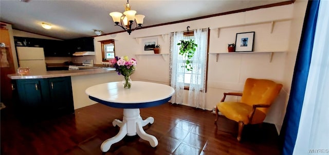 dining space with an inviting chandelier, lofted ceiling, and sink