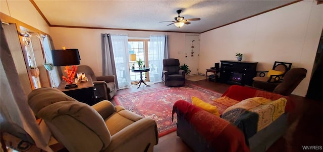 living room with hardwood / wood-style flooring, ornamental molding, and ceiling fan