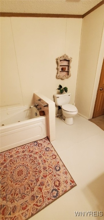 bathroom with tile patterned flooring, toilet, and a tub to relax in