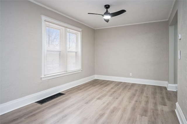 unfurnished room with ceiling fan, light wood-type flooring, and ornamental molding