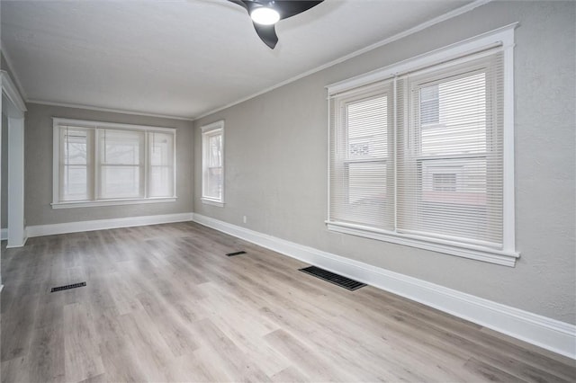 spare room featuring ceiling fan, crown molding, and light hardwood / wood-style flooring